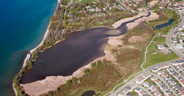 An ontario aerial view of a lake near a city.