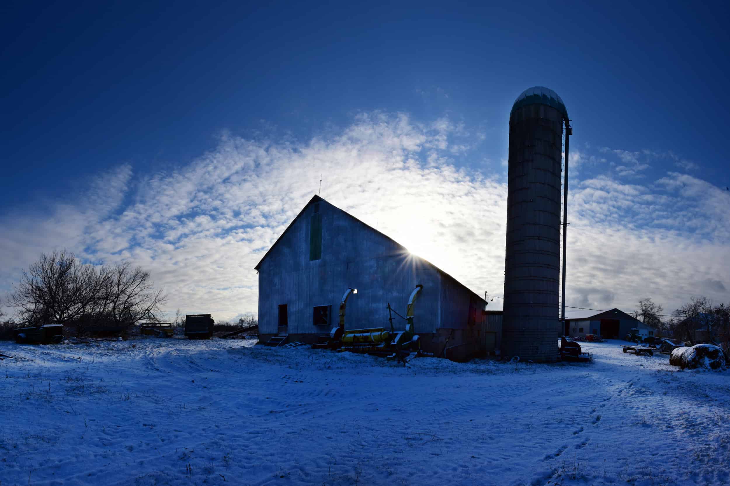 Nfu Ontario Accredited Farm Organization Farm Barn Silo Sunset 2500px A farm with a silo in the snow.