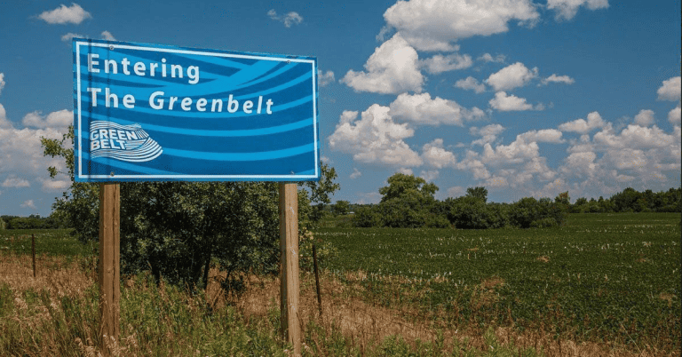 A blue and white sign indicating the entrance to Ontario's greenbelt.