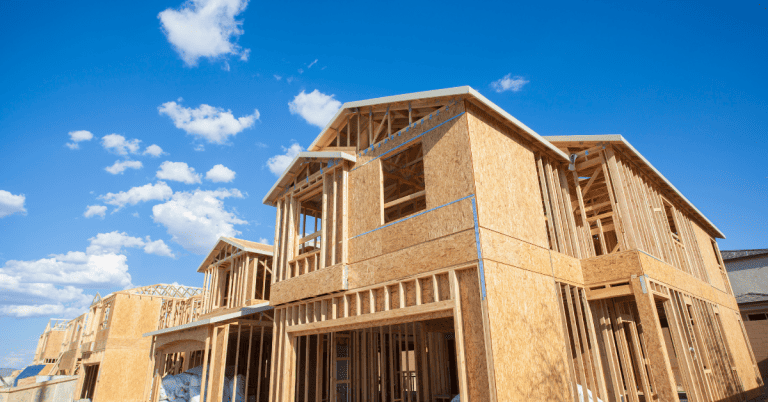 A new residential house getting built, showing the wooden framing and walls.