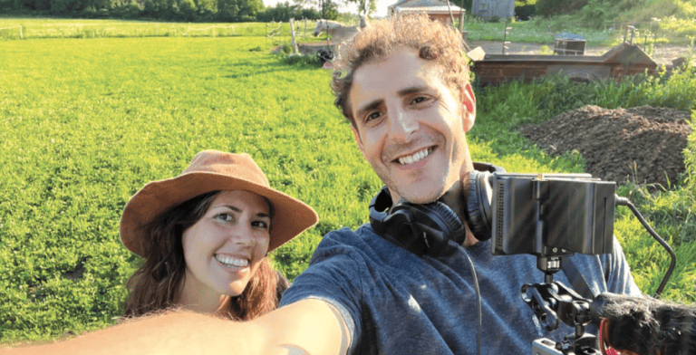 Award-winning documentary filmmakers, Tamer Soliman and Sarah Douglas taking a selfie in a field.