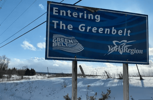 A sign that says entering the greenbelt region. Photo source: https://globalnews.ca/news/7656190/ontario-greenbelt-public-consultation-environment/