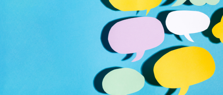 Paper speech bubbles on a blue background.