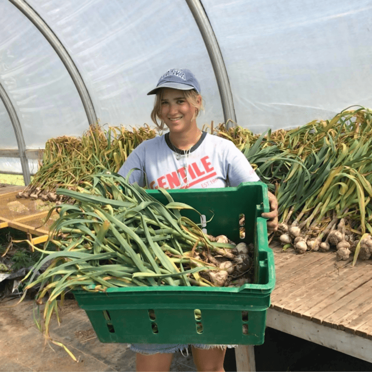 Briana Vanular holding basket of young onions.