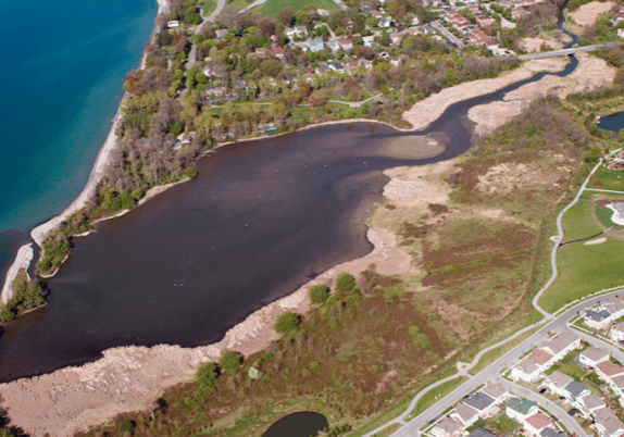 An ontario aerial view of a lake near a city.