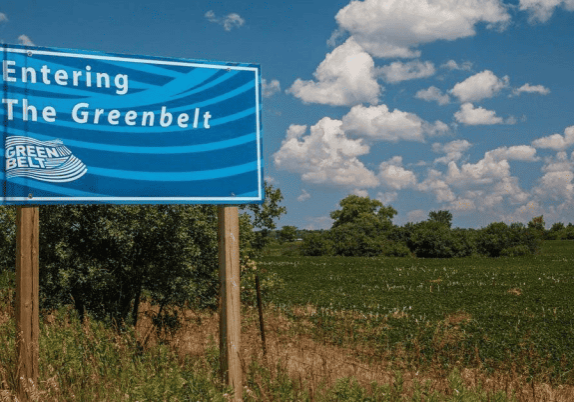 A blue and white sign indicating the entrance to Ontario's greenbelt.