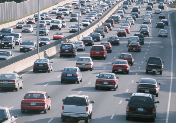 Flowing traffic of vehicles on an eight lane highway.