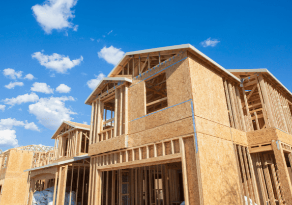 A new residential house getting built, showing the wooden framing and walls.