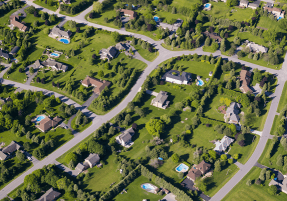 An aerial view of a residential neighborhood with large houses and yards.